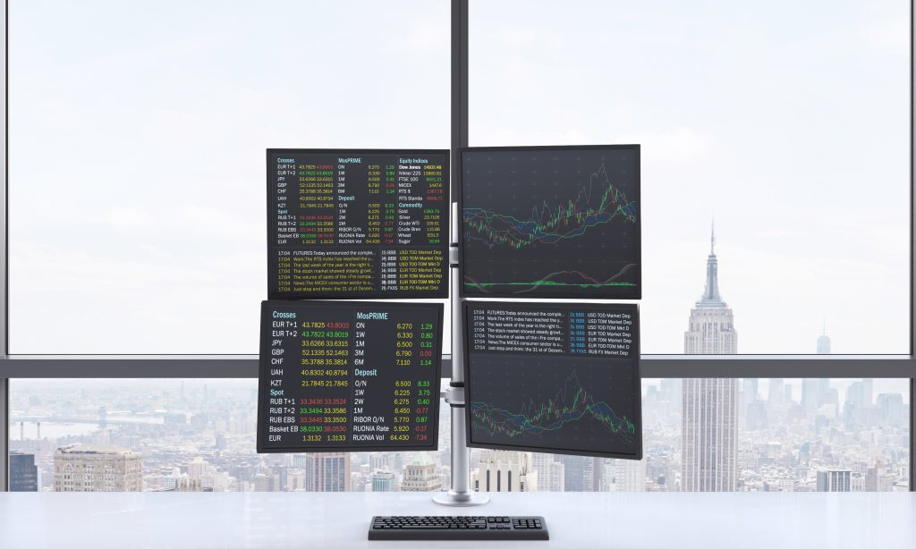screens showcasing current market trends with empire state building in the background